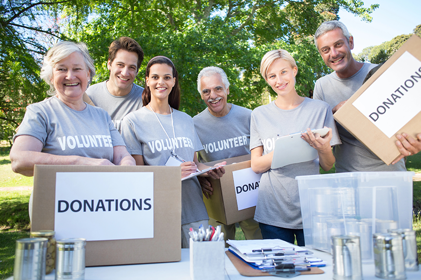 Volunteer family holding donation boxes
